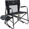 GCI Outdoor Freestyle Rocker XL in black, a portable folding camping chair with side table, drink holder, solid armrests, and a supportive backrest
